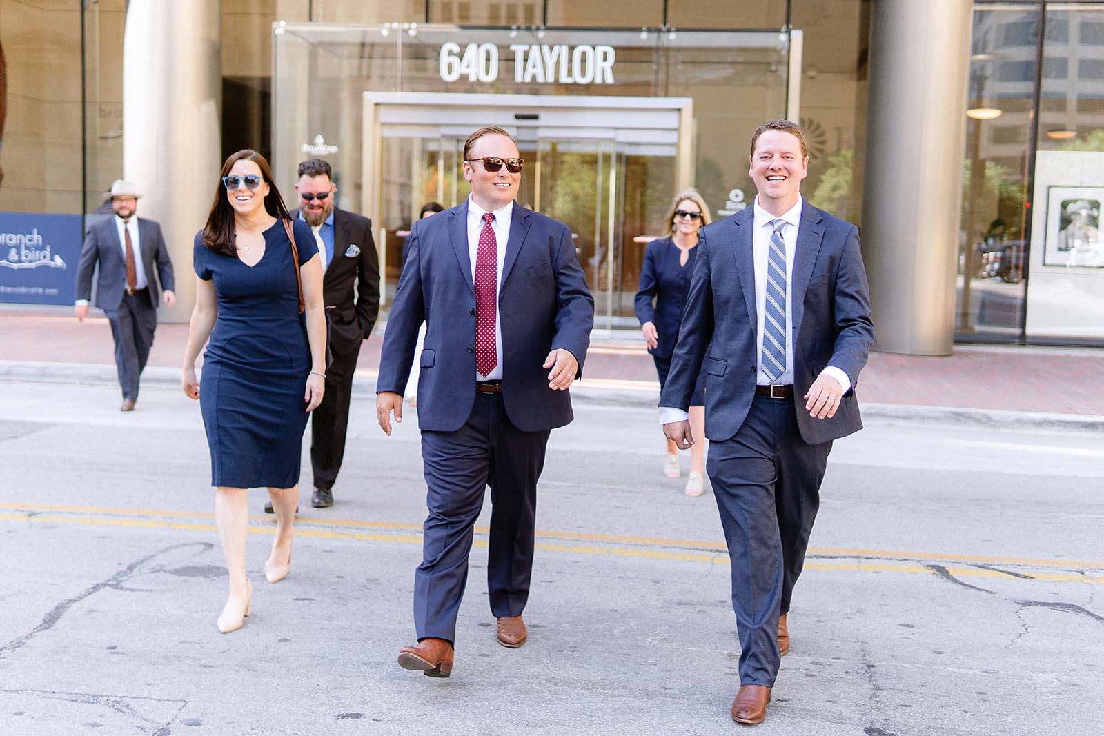 Image of attorneys and staff walking across the street in front of the office.